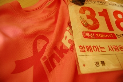 핑크 티셔츠 하나와 마라톤 참가 이름표 사진