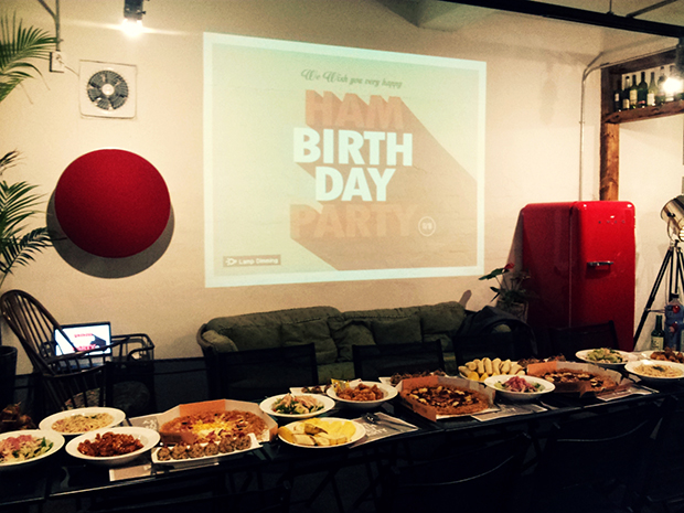 벽변 스크린에는 HAM BIRTH DAY PARTY라고 쓰여있는 스크린이 띄워져 있고, 그 앞으로 긴 탁자에 음식이 가득 놓여있다.