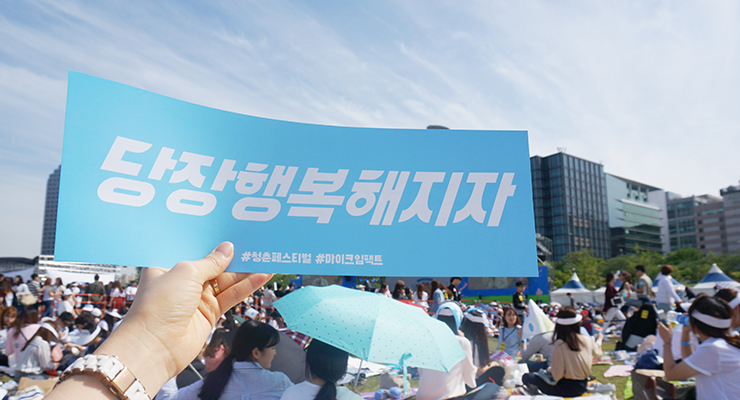 당장행복해지자 판넬을 들고있는 모습